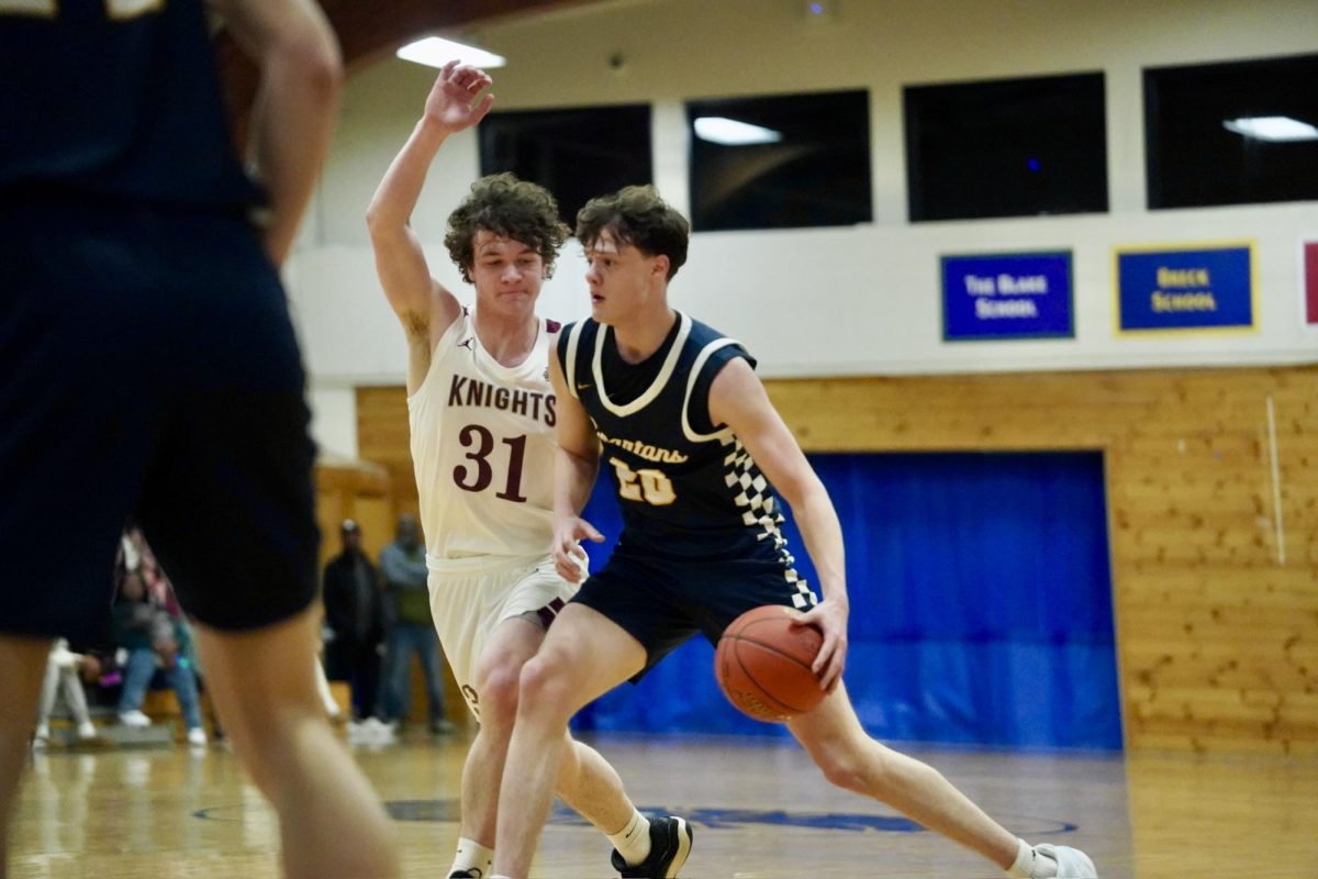 DRIVING DRIBBLE. Senior Nathan Rock  charges forward as his defender tries to block him. 