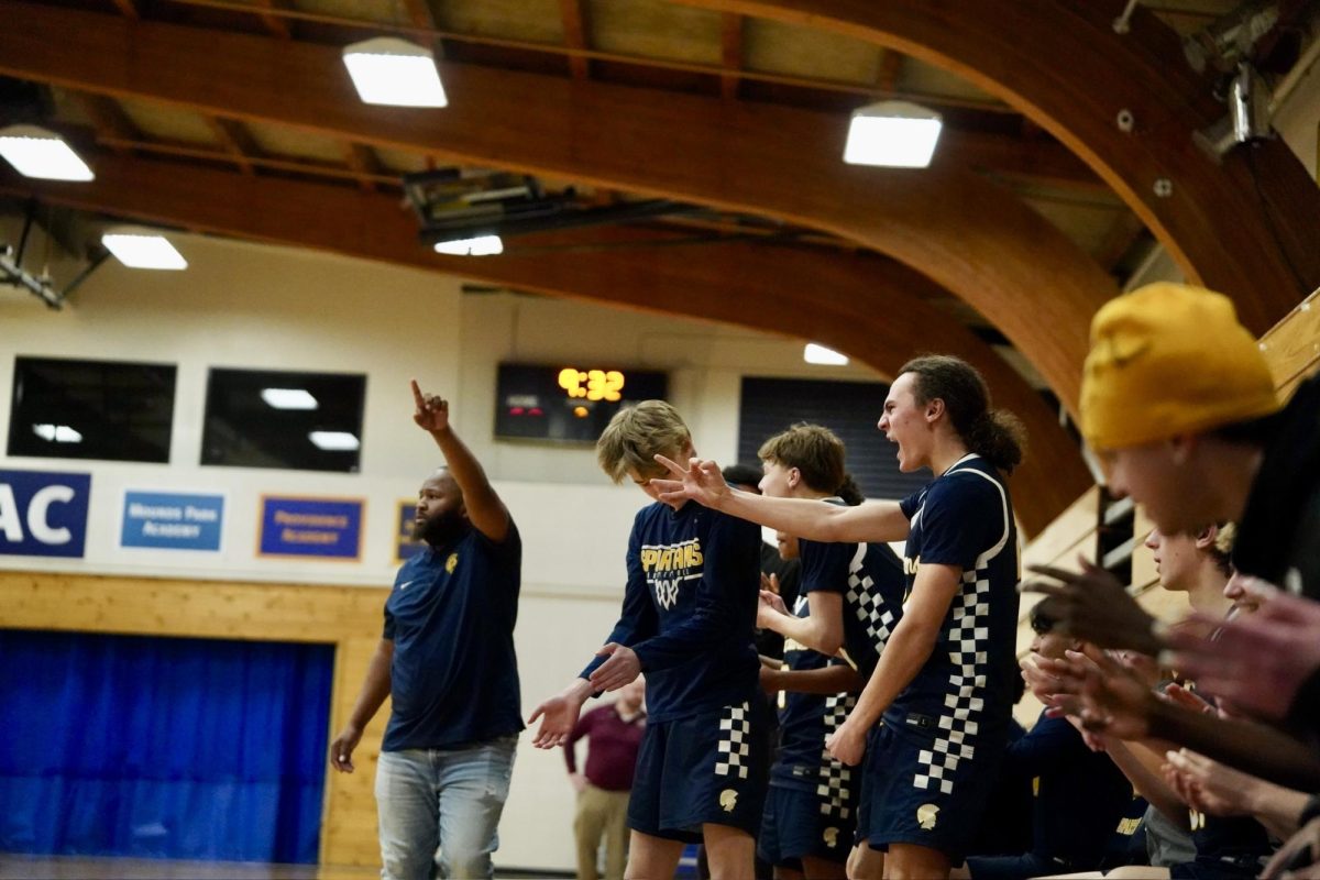 HYPE FOR THREE. Sophomore Langston Thompson hold up three fingers after his teammate sinks a three-pointer. 