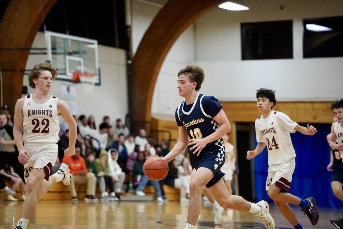DRIBBLE. Sophomore Miles Vogenthaler dribbles to the basket in hopes to gain more points for SPA. 