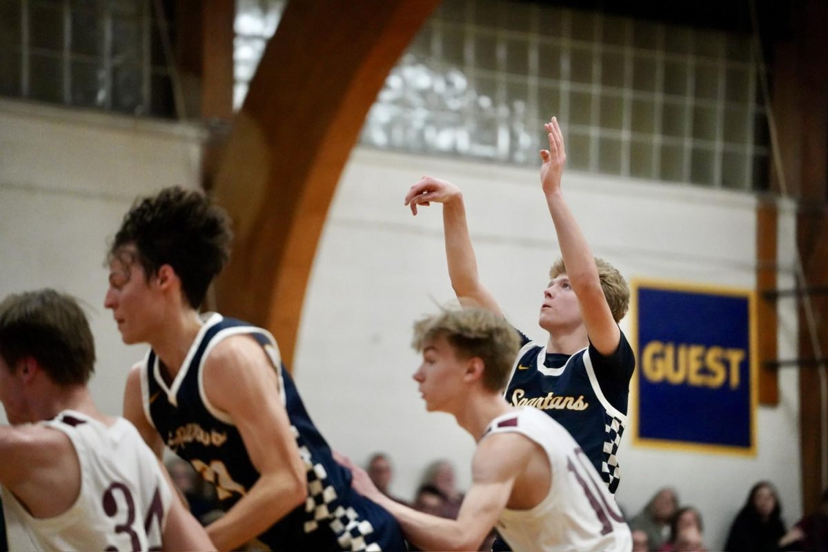 SWISH. Sophomore John Grimsrud shoots a free and watches to see if the ball goes in the net. 