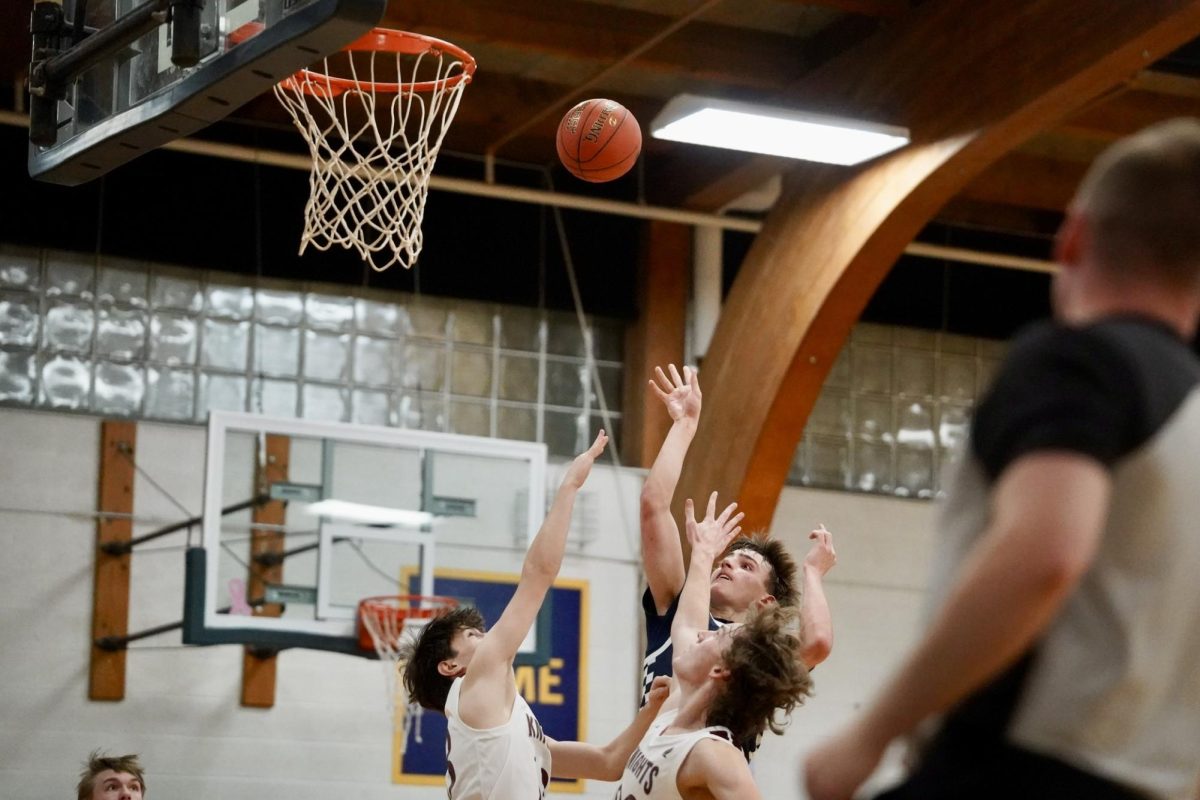 GAURDED. Sophomore Miles Vogenthaler takes the shot while on a 1v2.