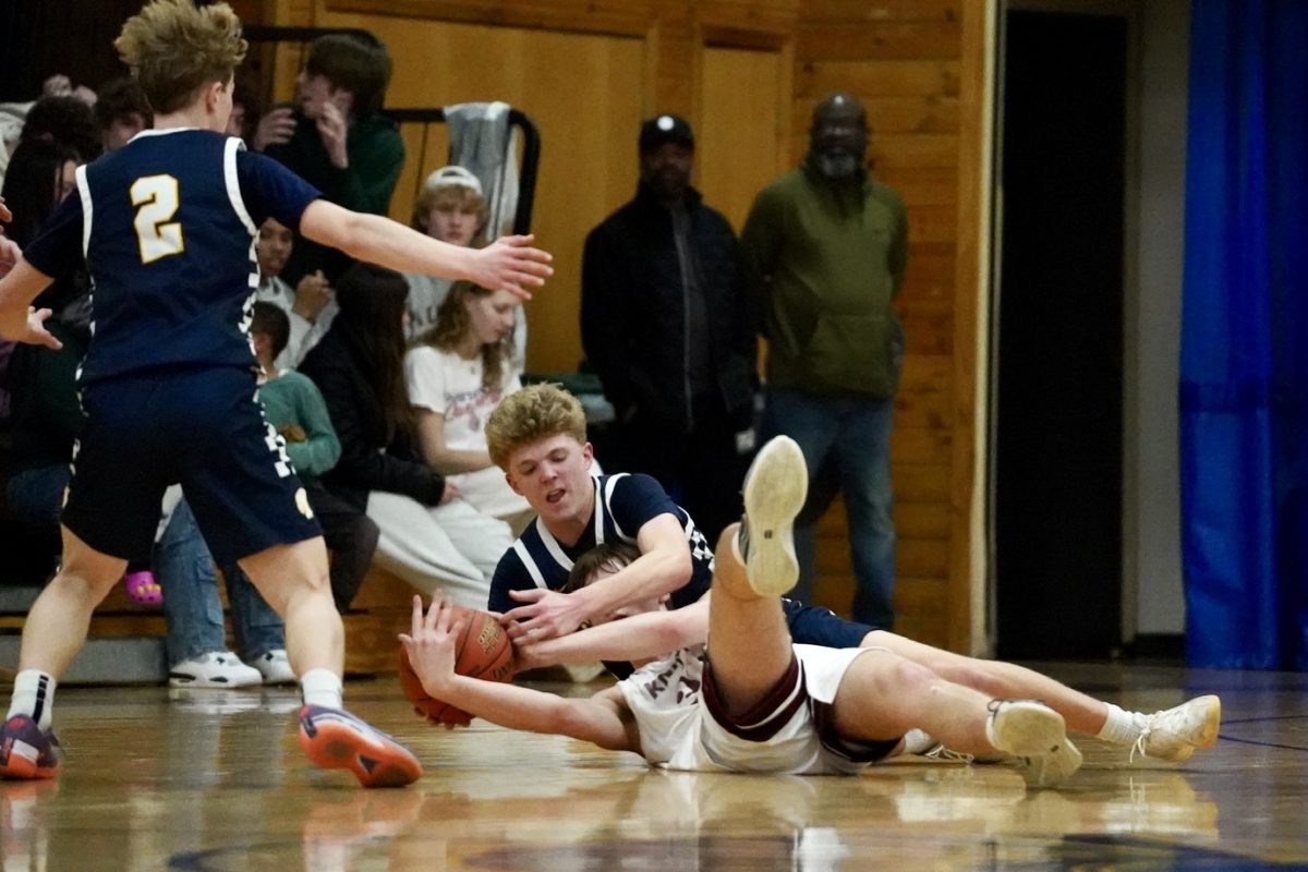 FIGHT FOR IT. Sophomore John Grimsrud fights to get the ball away from a Nova player.