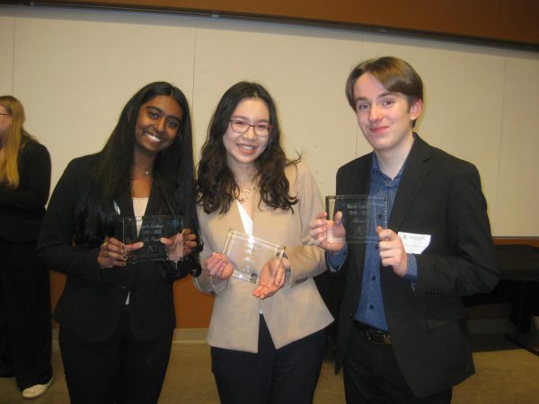 Proud prize winners, juniors Shefali Meagher and Huxley Westemeier, along with senior Deling Chen, smile with their awards. Meagher won fourth, Westemeier and Chen won sixth and seventh in the oral presentation category.
