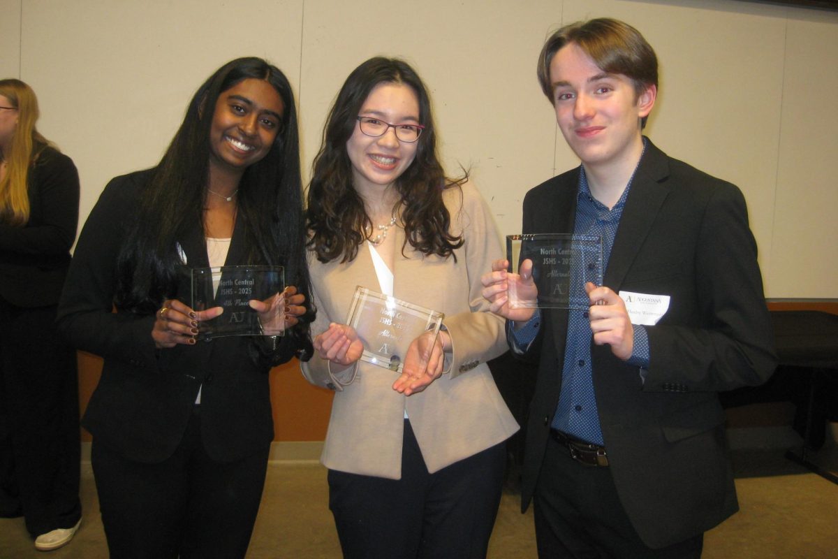 Proud prize winners, juniors Shefali Meagher and Huxley Westemeier, along with senior Deling Chen, smile with their awards. Meagher won fourth, Westemeier and Chen won sixth and seventh in the oral presentation category.