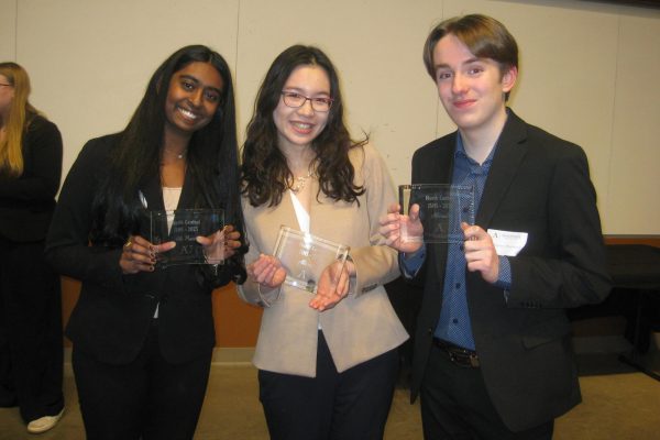 Proud prize winners, juniors Shefali Meagher and Huxley Westemeier, along with senior Deling Chen, smile with their awards. Meagher won fourth, Westemeier and Chen won sixth and seventh in the oral presentation category.