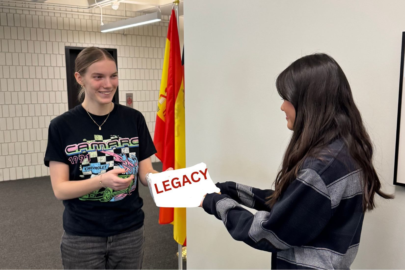 PASS IT ON. Senior Natalie Weibel passes on her legacy to a ninth-grader in SAC. 