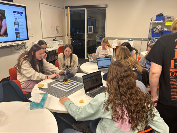 DESIGN. HerSpace members use their computers to create stickers.