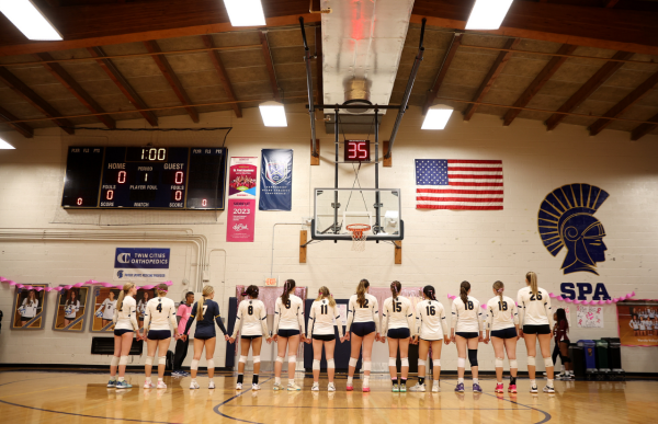 UNITY. he volleyball team stands together, hand in hand, embodying the strength and camaraderie of female athletes. Photo taken from SPA SmugMug.
