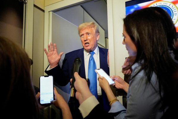U.S. President Donald Trump talks to members of the press aboard Air Force One during a flight to Joint Base Andrews, Maryland, U.S., April 6, 2025. REUTERS/Kent Nishimura/File photo
