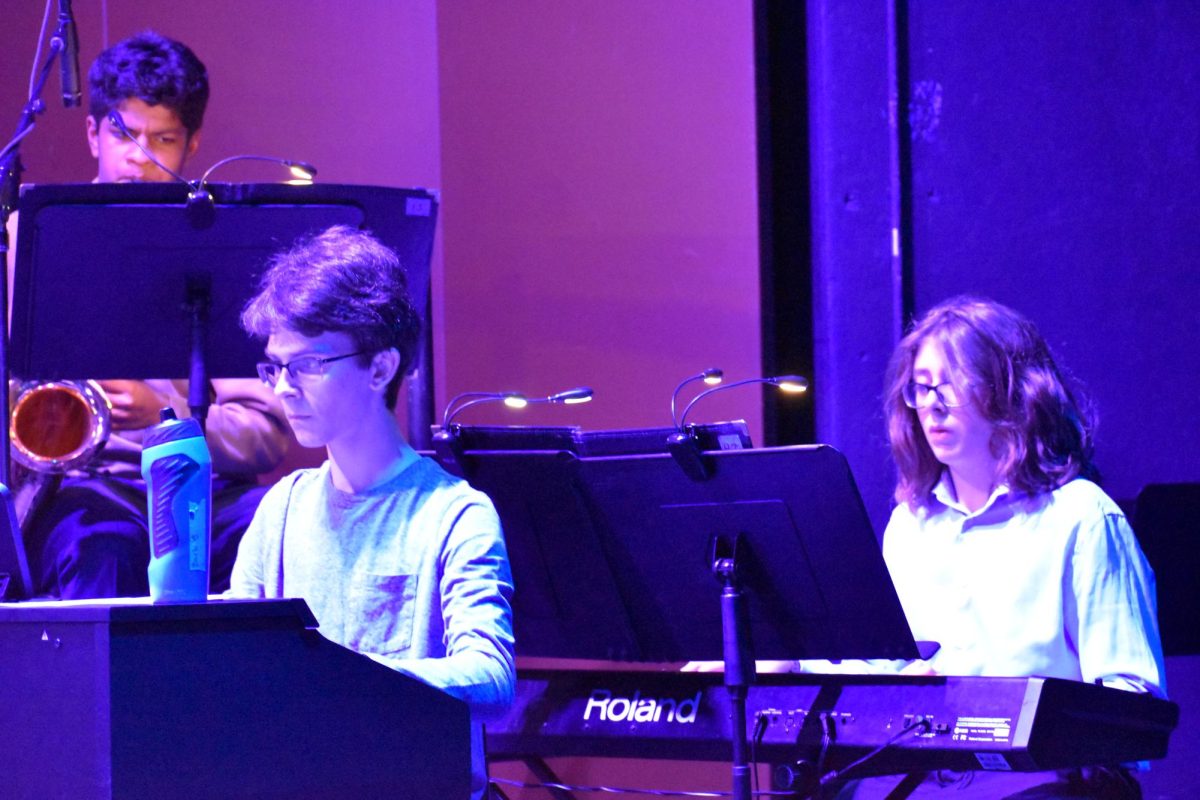 JAMES BOND-ESQUE. Sophomore Zach Berchenko and freshman Hank Harp infuse spy-movie vibes into "The Jazz Police" with their energetic piano riff.