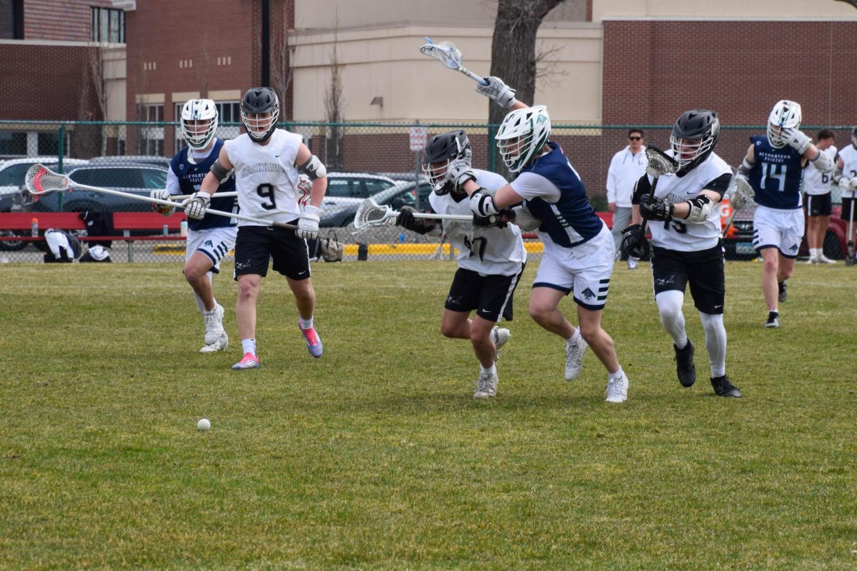 EYES ON THE PRIZE. Players sprint after the ball.