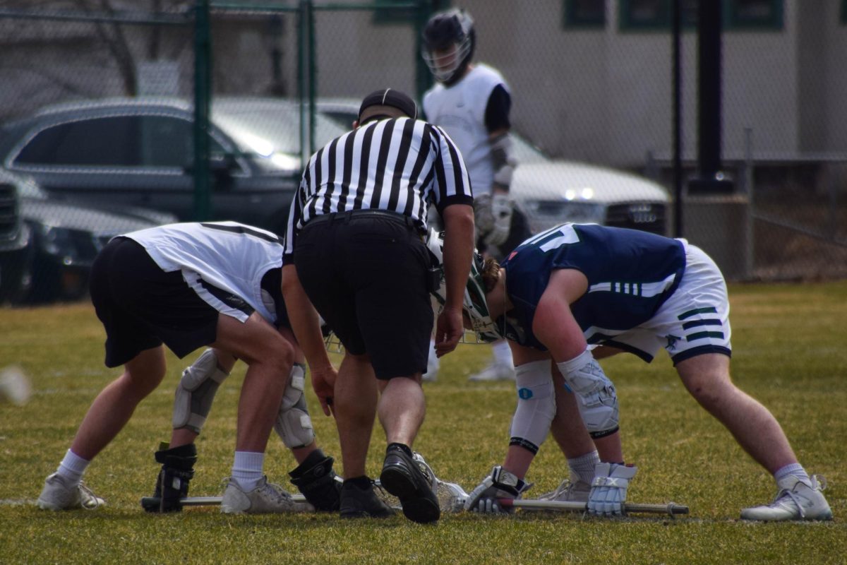 FACE-OFF. Players from each team prepare for the ref to drop the ball into play.