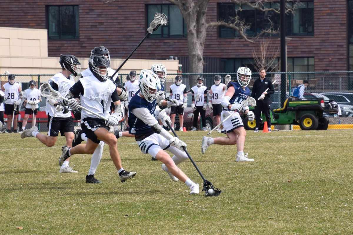 HOT PURSUIT. Blackhawks players chase after the player with the ball.
