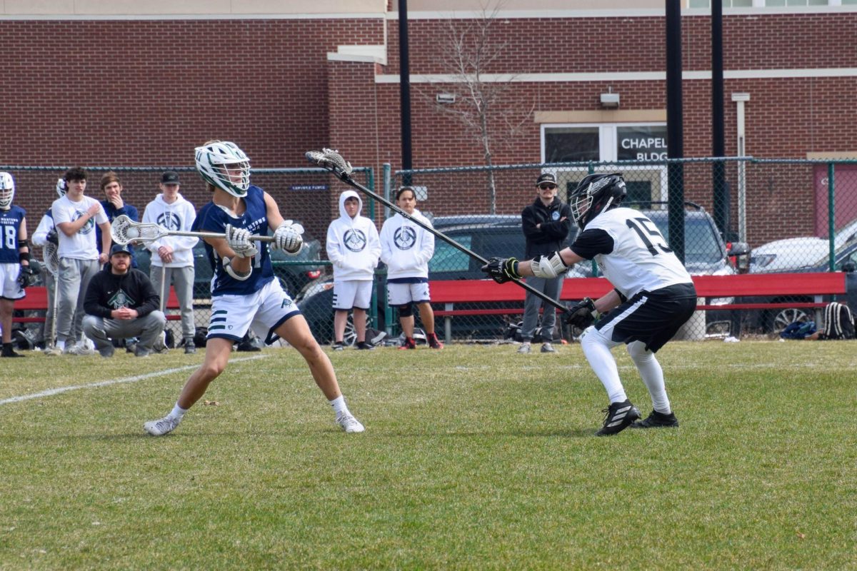 DUEL. Senior Josh Holloway faces off against an opposing attackman.