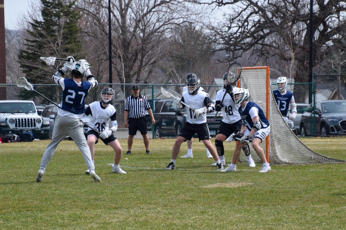 TIME HAS FROZEN. Blackhawks defenders prepare to block a shot.