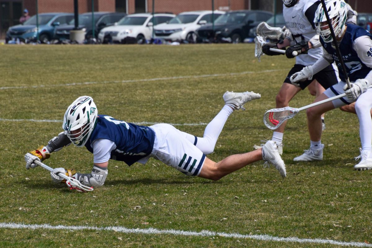 FULL COMMITMENT. An opponent dives for the ball.
