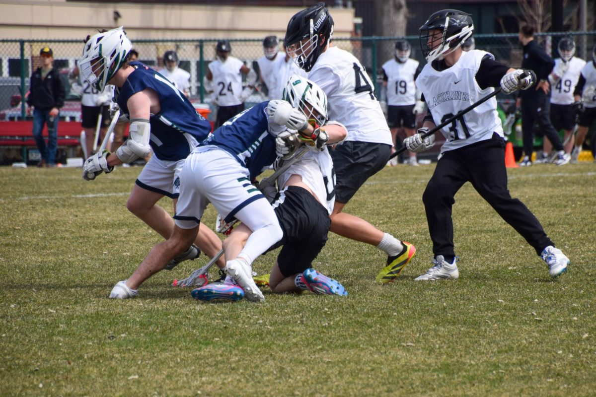 GETTING PHYSICAL. Senior Dylan Bump gets charged by a opponent.