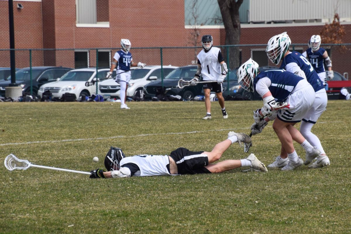 SPRAWLED. A Blackhawks player is downed and he loses the ball. 