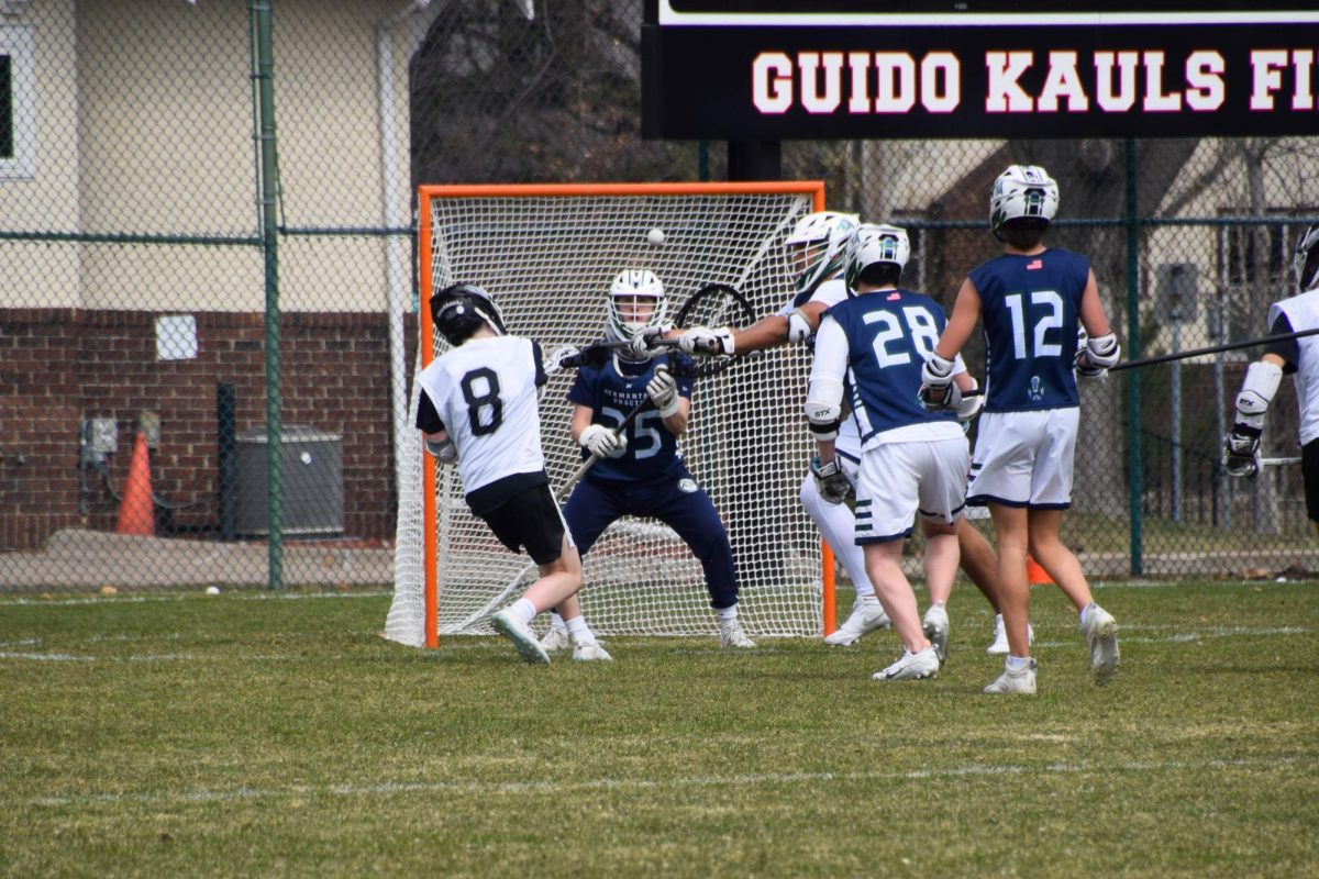 SHOT ON GOAL. Junior Gabe Devereux fires a shot in the midst of three defenders.