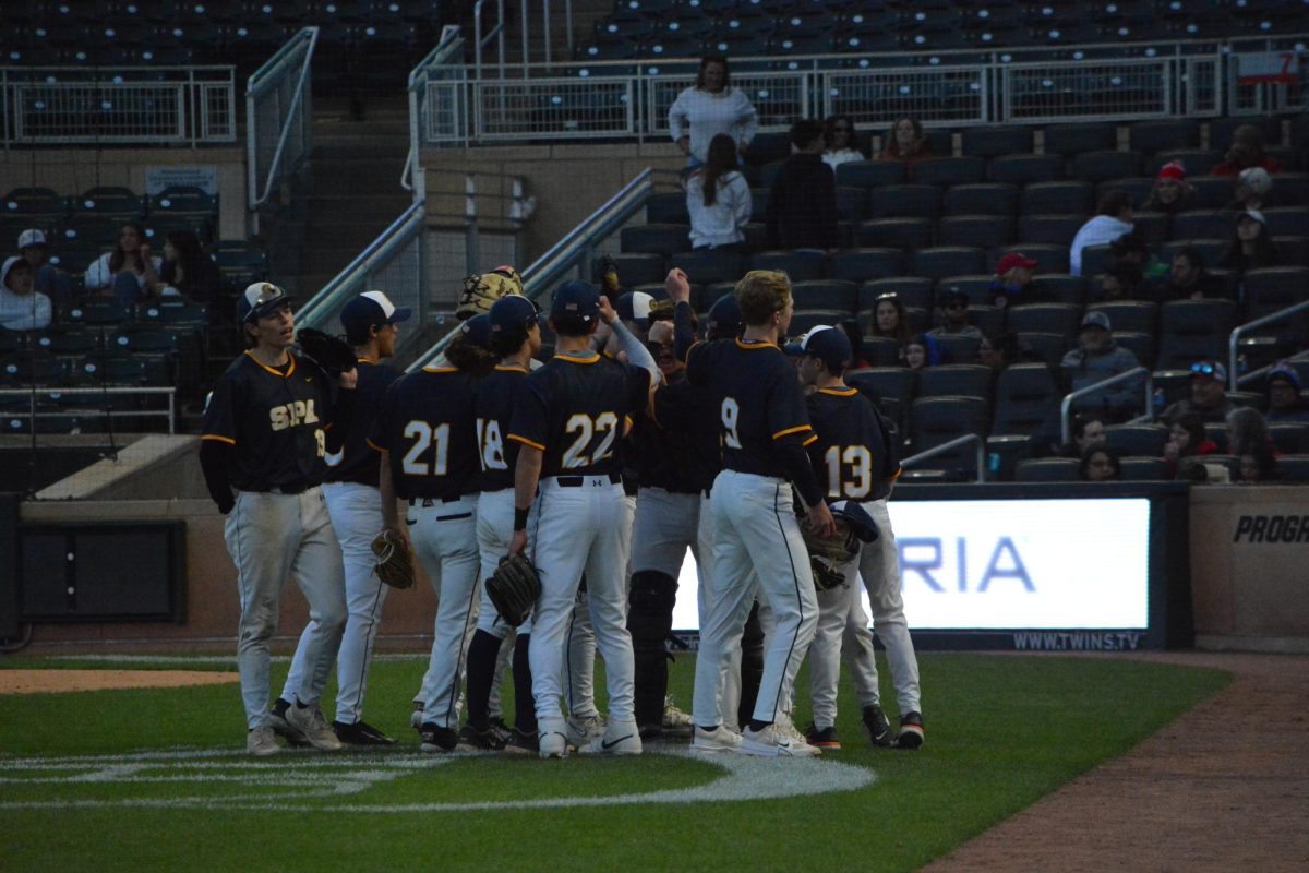 LOCKING IN. The team huddles up before their game at Target Field