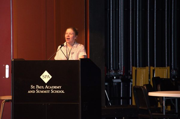 OPEN MIC. English teacher Anne Boemler introduced the assembly before launching into a poem of her own.