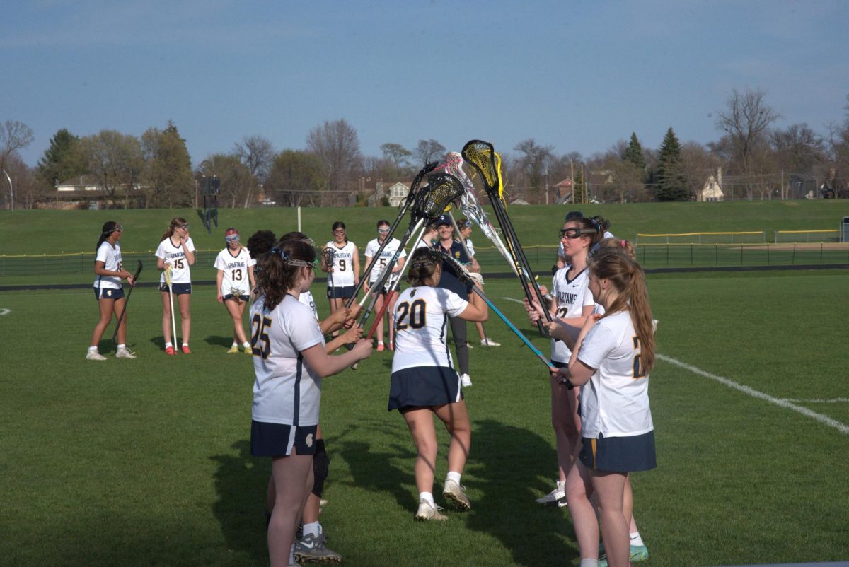 STARING LINE UP. Sophomore Stella Hunter runs through the tunnel after her names gets called to start. 