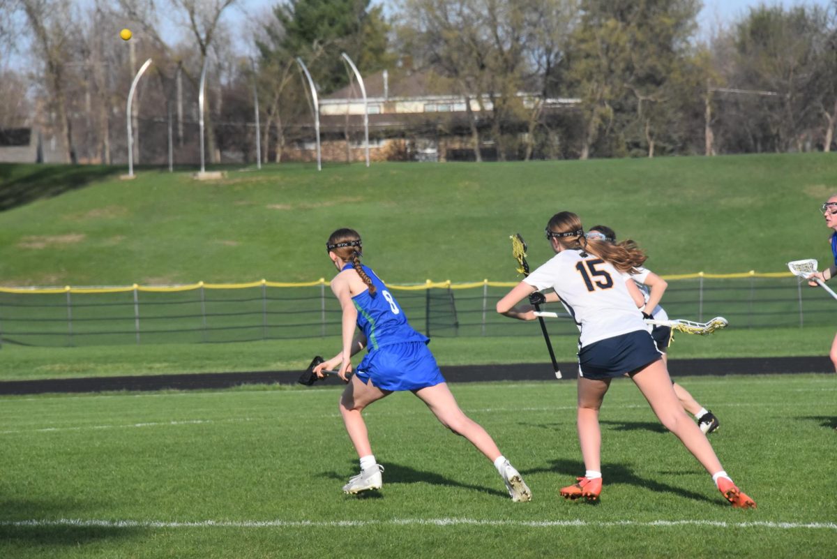 RUN FOR IT. 9th grader Sylvia Westra runs for the ball after it getting intersected. 