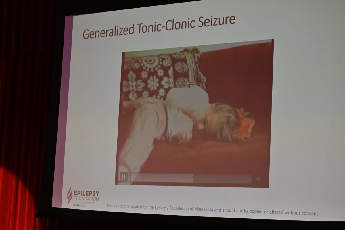 INFORM. Williams projects a video example of a Generalized Tonic-Clonic Seizure. The presentation included multiple examples of varied types of seizures. “These types of seizures may look painful,” Williams said, but he emphasized that that is not the case. 