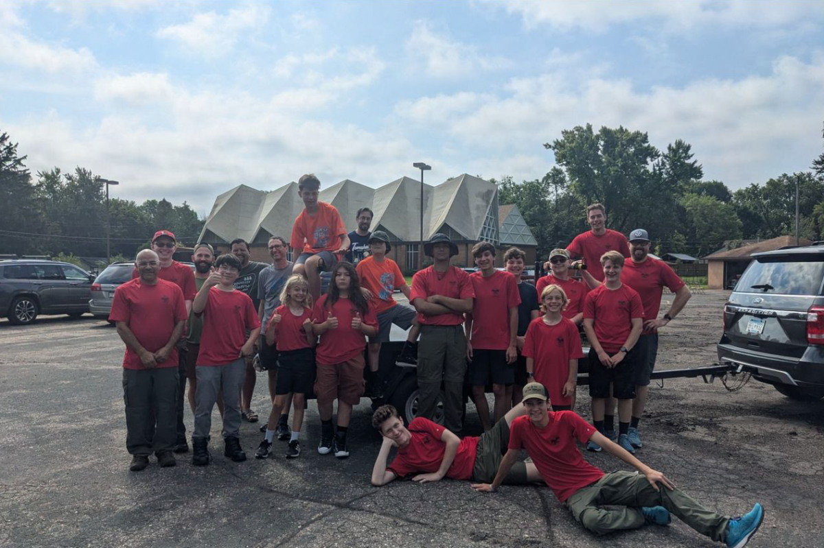 Adams (front right) sits with his Troop 9419 after a weekend of service projects and environmental cleanups at Tomahawk, a Boy Scout-run campsite. (Submitted photo by Hugh Adams)