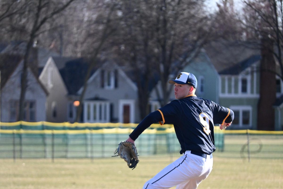 WIND UP. Sophomore John Grimsrud throws a pitch at top speed.