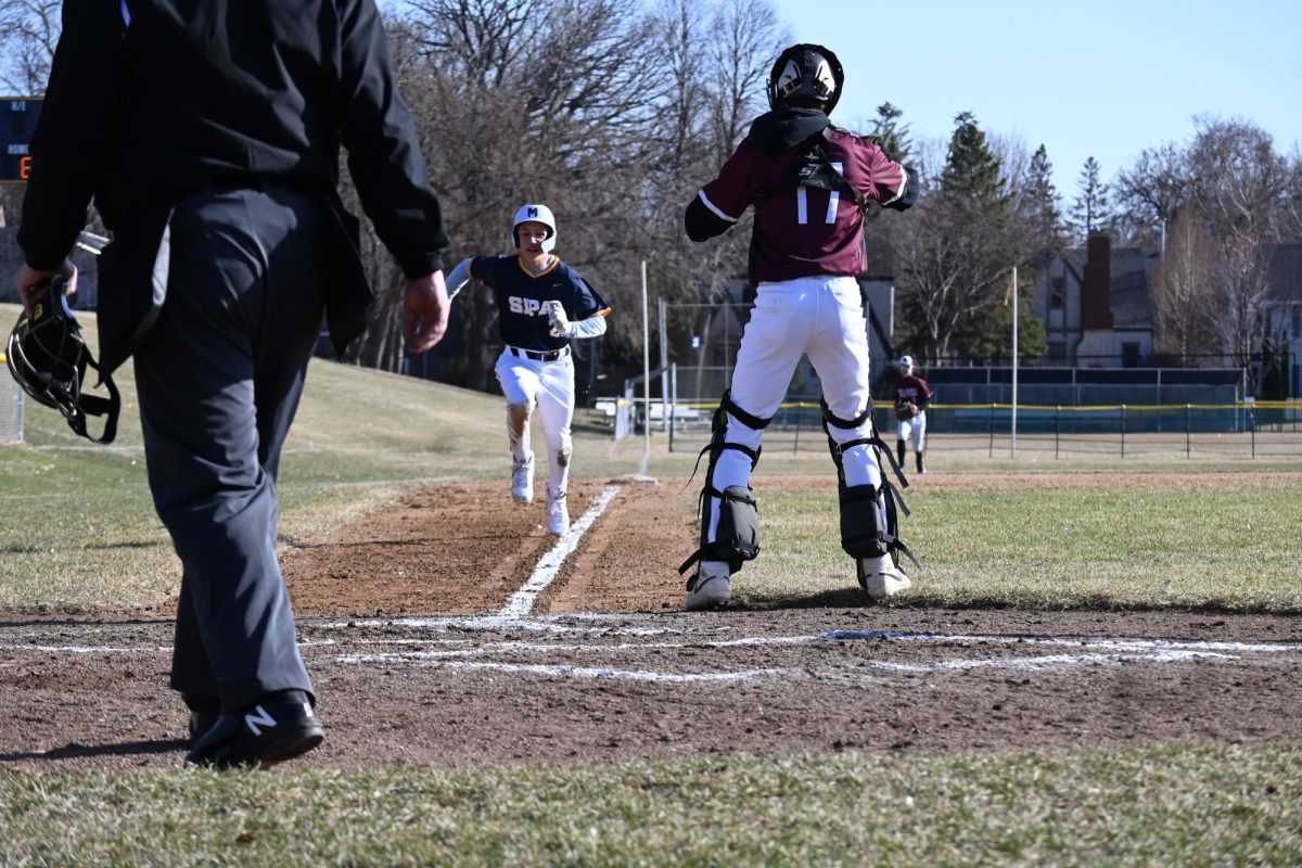 ALMOST THERE. Eighth-grader Quinn Wall sprints to home base.