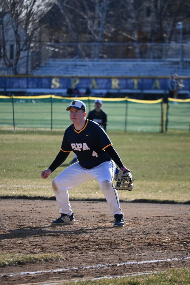 FIRST BASE FIRST PLACE. Junior Peter Ostrem covers first base excellently, deftly catching fly balls and delivering force-outs.