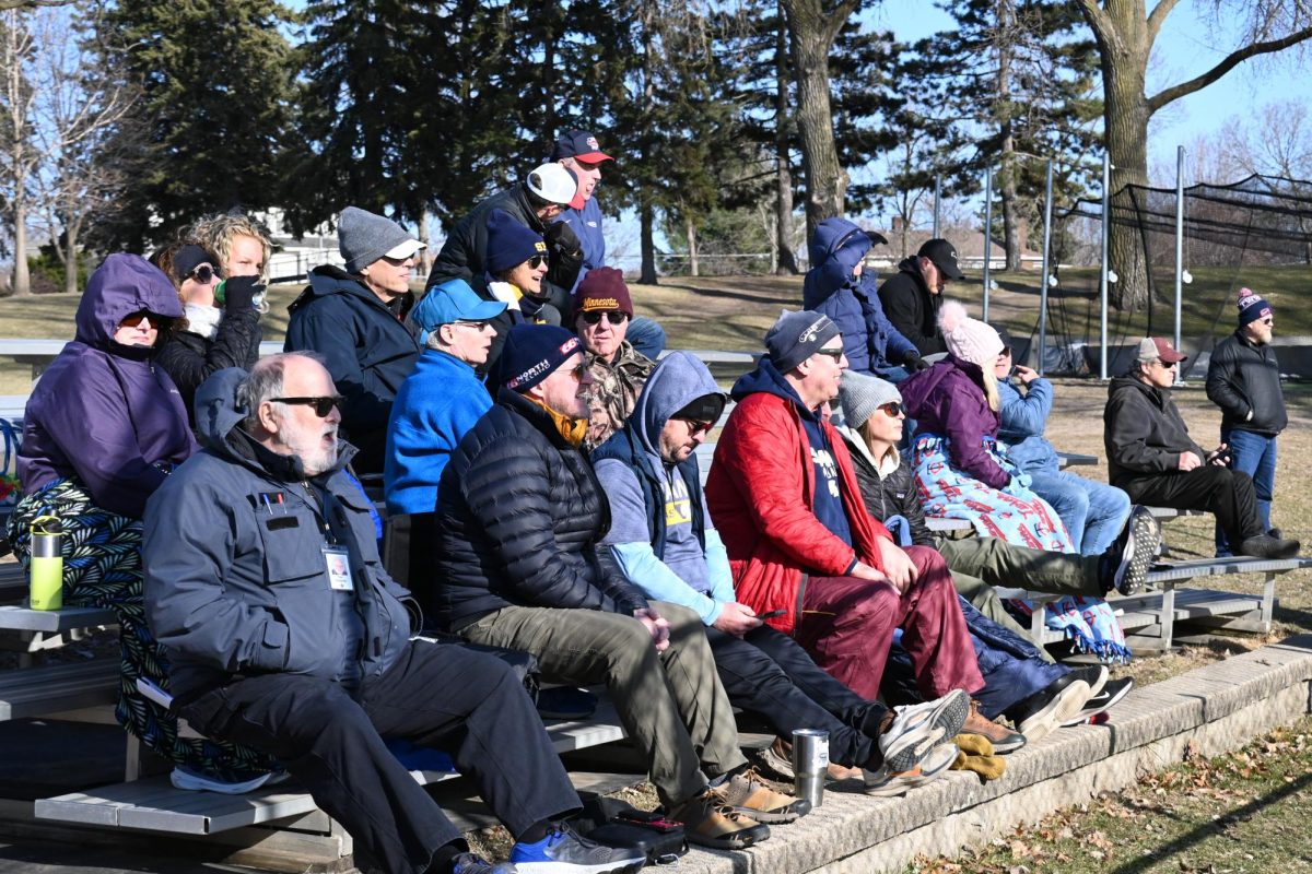BUNDLED UP. Parents and fans cheer on the team.