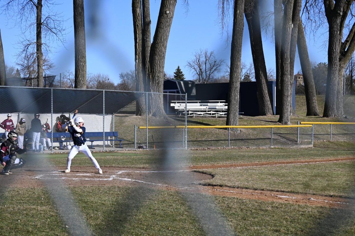 HEAD HIGH. Sophomore Henry Fenlon prepares to hit the ball.