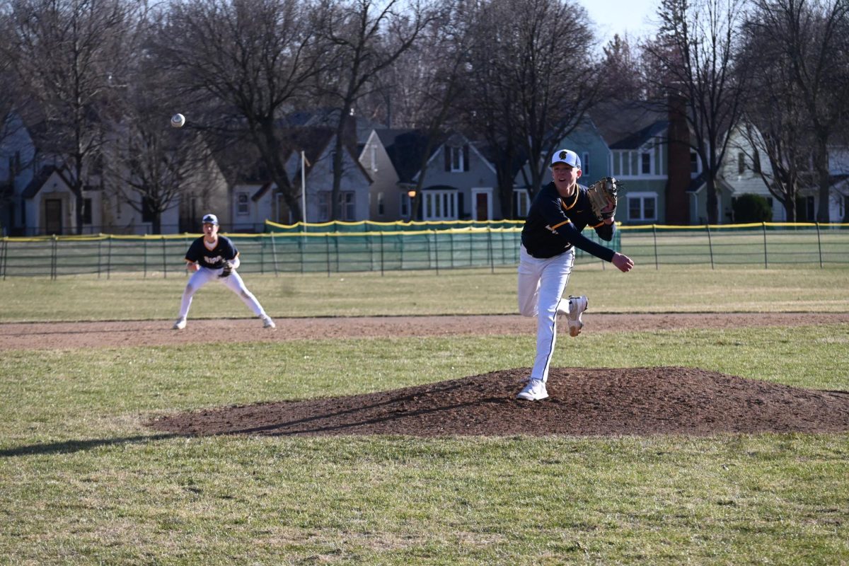 ...AND THROW. Sophomore John Grimsrud pitches for the Spartans.