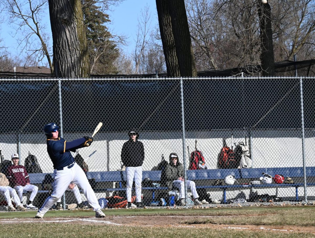 DOUBLE TROUBLE. Junior Cutler Crook  smashes a double right after his teammate, junior Peter Ostrem, did the same.