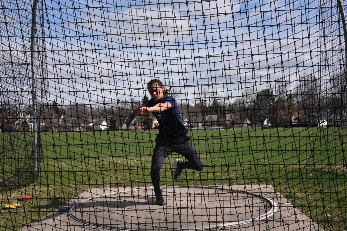 FLY IT FAR. Sophomore Langston Thompson prepares to throw the disc as far as he can. Discus required a large amount of momentum from Thompson, forcing him to turn a full 360 degrees to set up the perfect throw. 