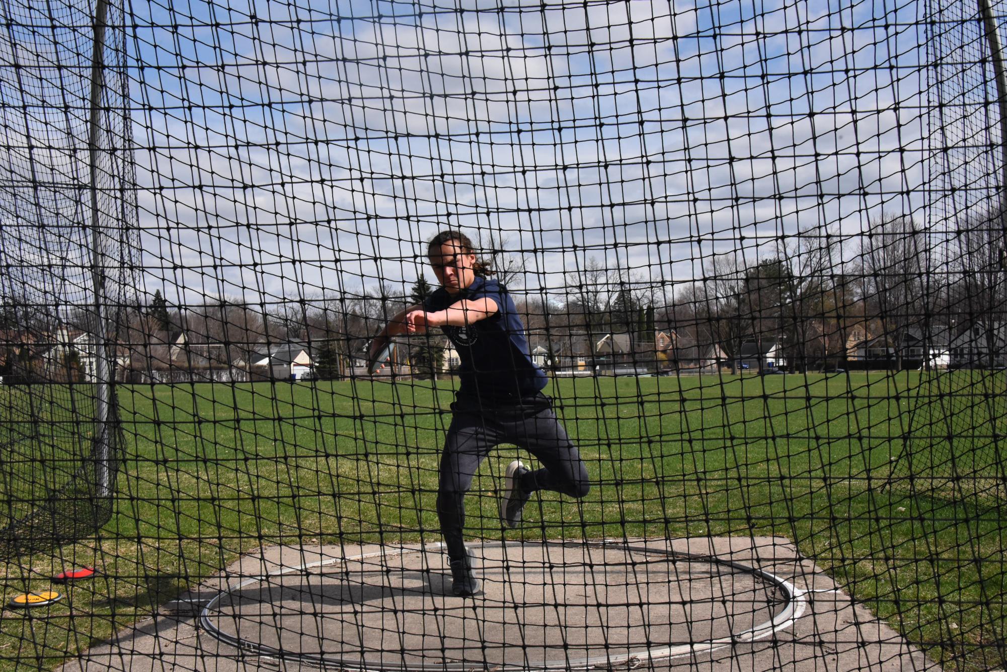 FLY IT FAR. Sophomore Langston Thompson prepares to throw the disc as far as he can. Discus required a large amount of momentum from Thompson, forcing him to turn a full 360 degrees to set up the perfect throw. 