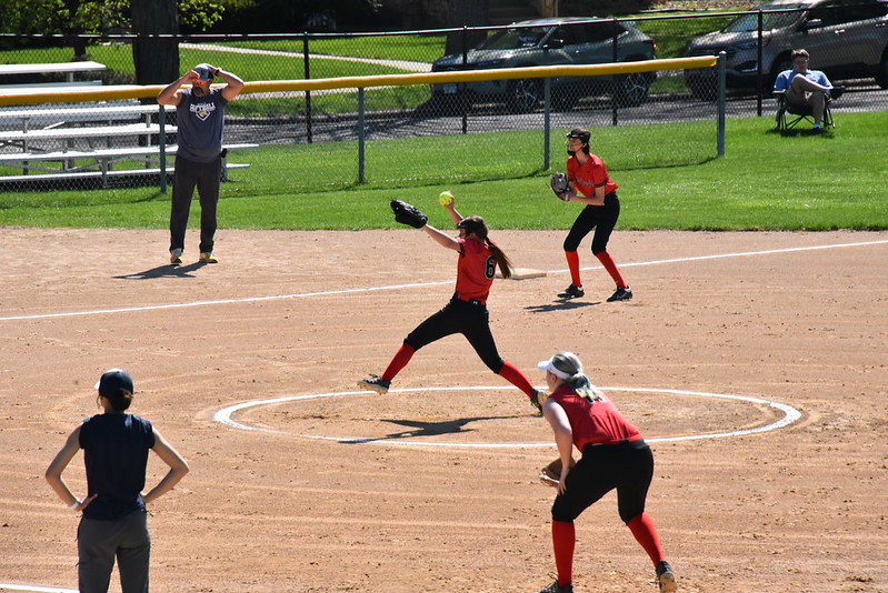 “PITCHER” THIS: One of the Redhawks’ pitchers winds up to throw a tough one. The first and third basemen can be seen in defensive positions, ready to chase a ball or a runner. Breck coaches are pictured in the designated coaches boxes near first and third base. 