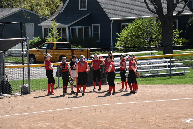 WORDS OF WISDOM: The Redhawks met in a huddle between innings, sharing words of encouragement before going into the outfield. Even though they were losing consistently throughout their first game, the team remained cheerful.