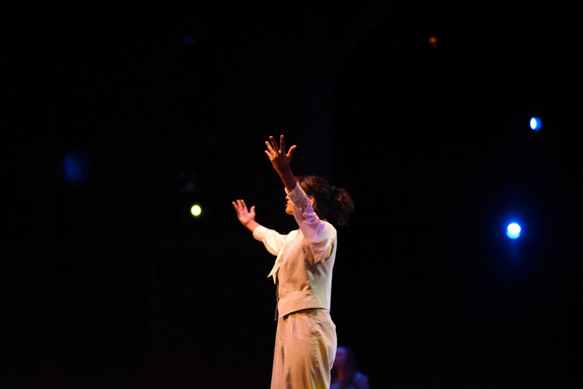 VOILÀ. Missus Hermes (Aarushi Bahadur) raises her arms to the crowd in triumph. Hermes played a key role in the crowd's engagement in the production. 
