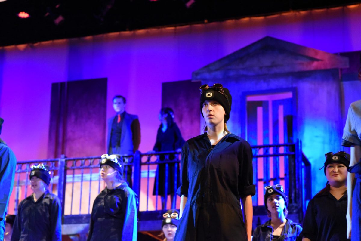 KEEP YOUR HEAD LOW. Sophomore Ivy Evans stares into the crowd when reporting to Hades.