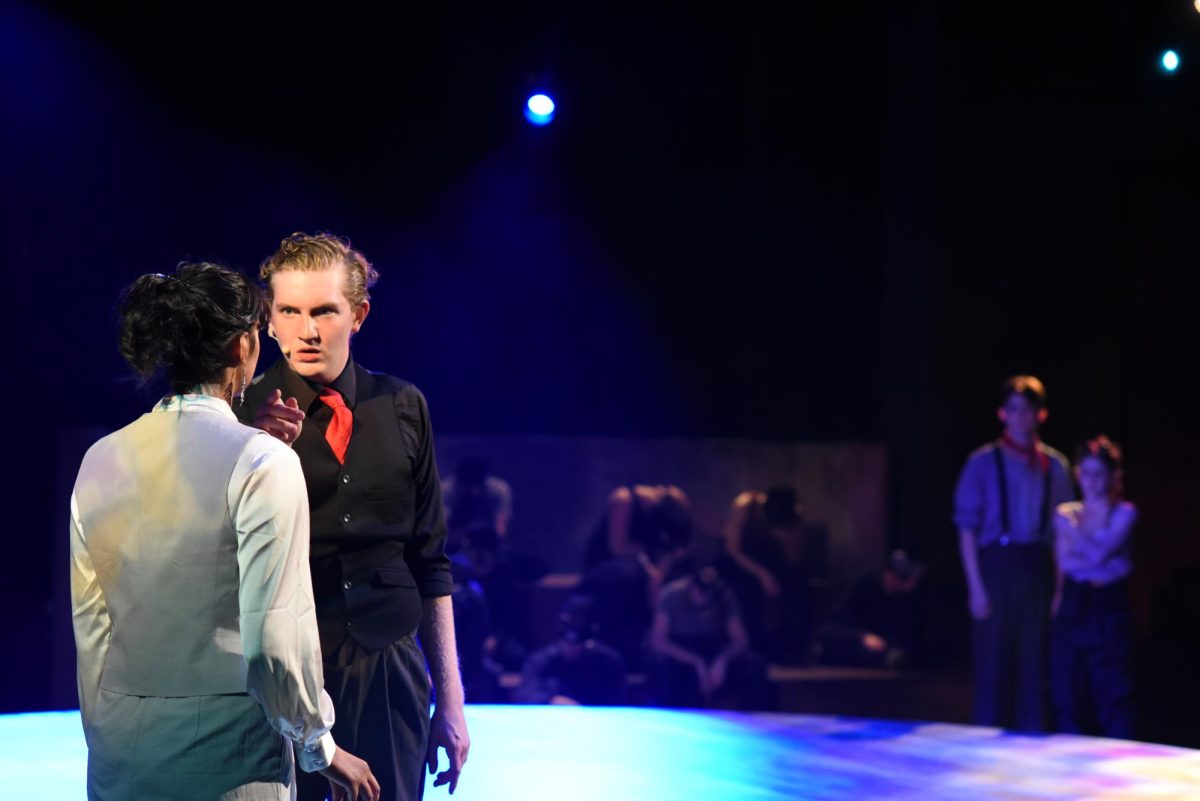 STERN. Hades (William Hanna) is seen intimidating Hermes (Aarushi Bahadur) while Eurydice (Maddie Pierce) and Orpheus (Coda Wilson) huddle behind them. 
