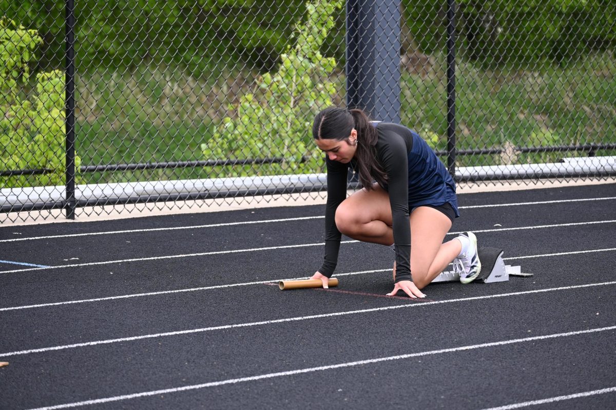 RELAY. Ninth-grader Sophie Ferrer waits in the blocks for the 4x200 meter relay. They placed third.