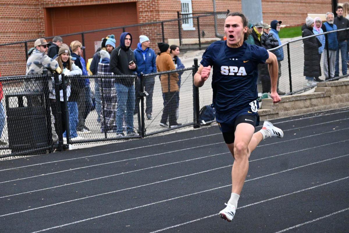 ALMOST THERE. Sophomore Langston Thompson drives his arm as he aims for the finish line. He finished first in his 200 meter heat.
