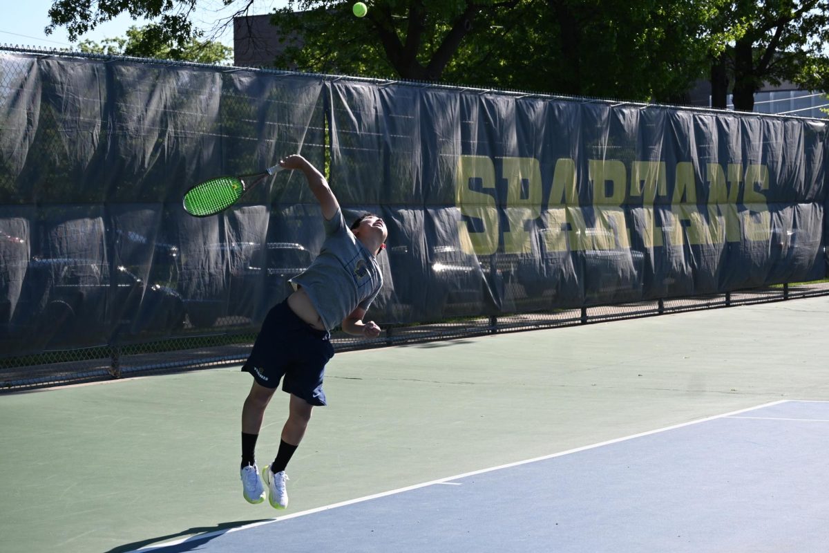SOPHOMORE ALLAN WANG LOCKS IN ON HIS SERVE. Wang and teammate Isaak Senaratna battled through tough matches to earn second place in doubles, highlighting the program’s rising talent.