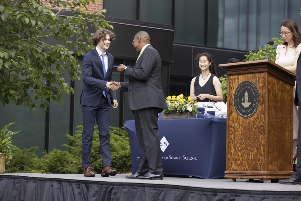 DESERVED DIPLOMA: US principal Minnie Lee announces Henry Giles ('24) just before he receives his diploma from 
Head of School Luis Ottley. USC presidents organize diplomas, with 24-25 co-presidents Annie Zhang pictured.