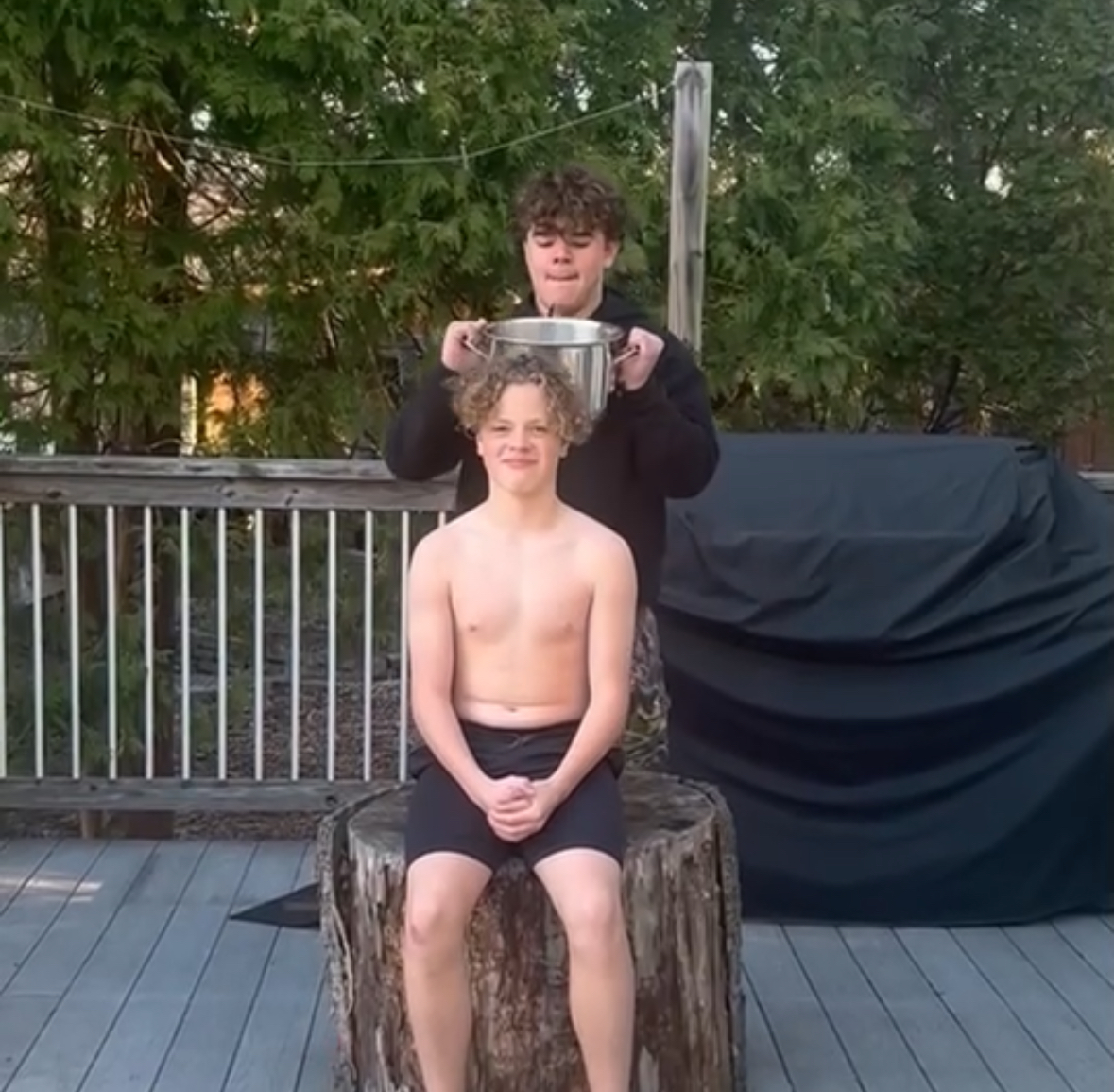 Junior Fletcher Coblentz prepares to dump the freezing water onto his younger brothers head. 