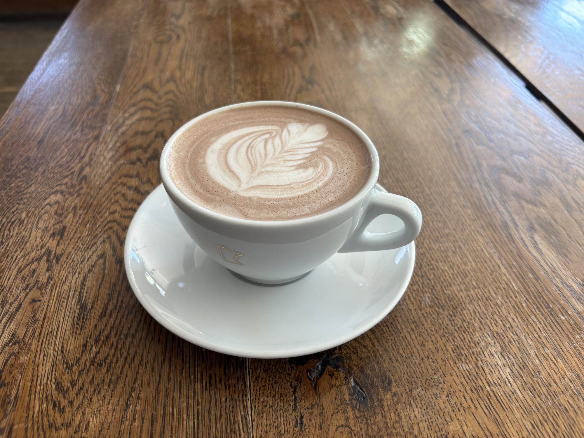 A CUP OF ART. Baristas make a beautiful pattern atop a warm cup of hot chocolate.