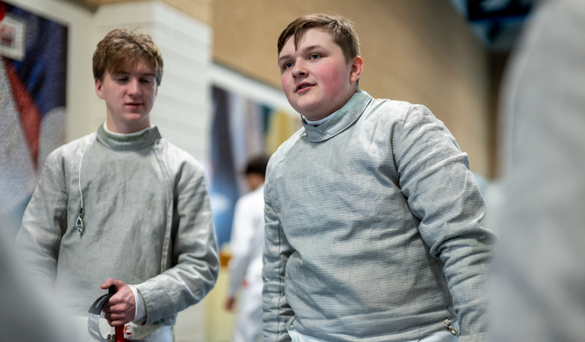 FIRE FENCING. Junior Howard Huelster talks to his teammates before he competes. Photo from SPA SmugMug.